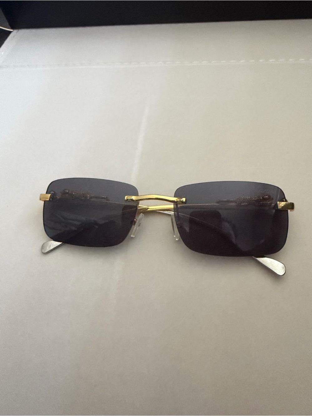 Cartier Gold Rimless Sunglasses with Dark Gray Lenses